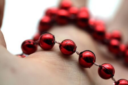 hand with red pearlsの写真素材