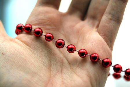 hand with red pearlsの写真素材