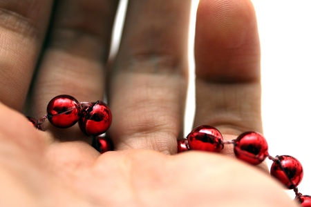 hand with red pearlsの写真素材