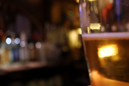 blurry beer mug in a barの写真素材