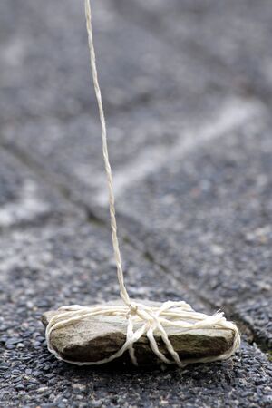 stone weight on a ropeの写真素材