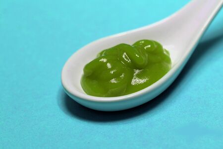 poisoned colored spice on a porcelain spoonの写真素材