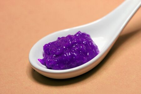 poisoned colored spice on a porcelain spoonの写真素材
