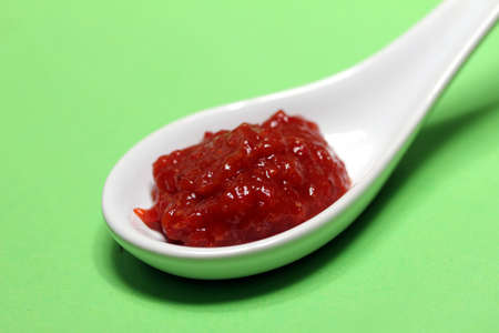 hot sauce on a spoonの写真素材