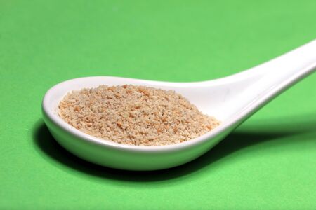 whole wheat flour on a porcelain spoonの写真素材