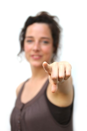 young woman pointing with finger at viewerの写真素材