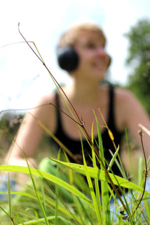 girl on meadow with headphonesの写真素材