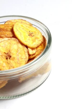 a bowl of banana chipsの写真素材