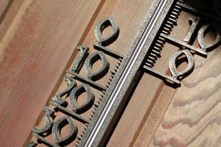 thermometer numbers on a sunny wooden wall
