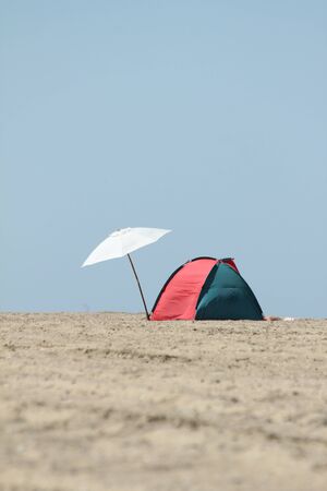 lonely parasol and sun tent on the beachの写真素材