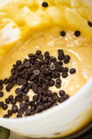 a yellow dough with chocolate dropsの写真素材