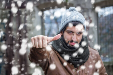 smiling beard man making thumps up in snowfallのeditorial素材