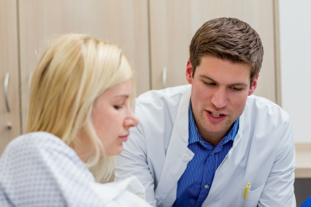 doctor talking with female patient in a hospitalの写真素材
