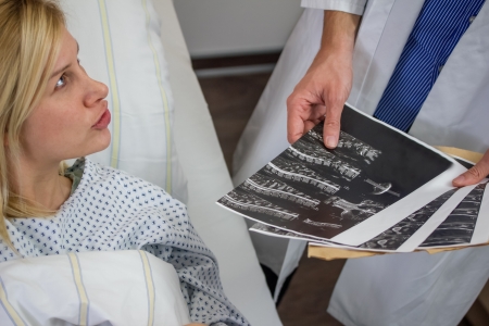 doctor talking with female patient in a hospitalの写真素材