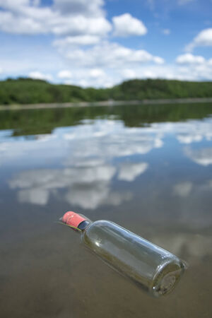 a plain bottle at a lakeの写真素材