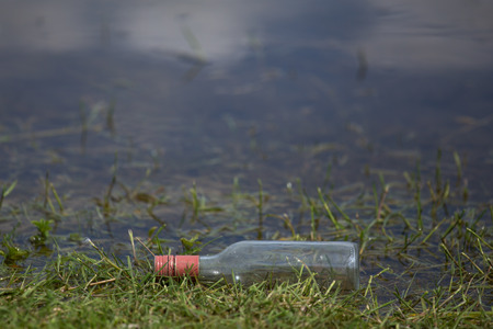 a plain bottle at a lakeの写真素材