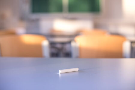 class room background with a chalk piece in frontの写真素材