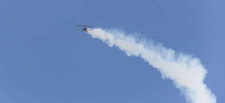 stunt flyer airplane in the sky