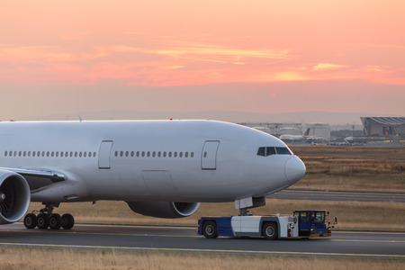 airplane beeing towed on a runwayの写真素材