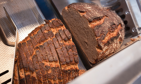 slicing a fresh baked breadの写真素材