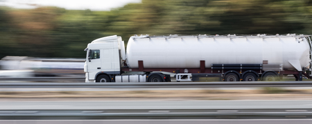 gasoline transportation truck on highway speed blurの写真素材