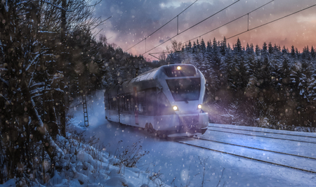 train speeding in a snowy winter nightの写真素材