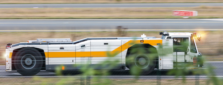 airport tractor speeding near the runwayの写真素材