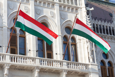 hungarian national flags on the hungarian parliament buildingの写真素材