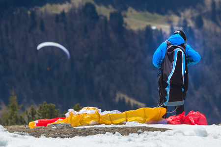 paraglider preparing to start in the mountainsの写真素材