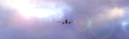 an airplane flying through an evening cloudscape panoramic viewの写真素材