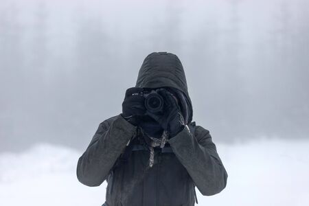 photographer in an foggy winter landscape panoramaの写真素材