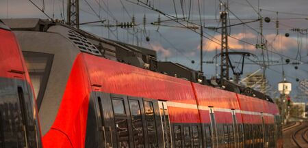 red passenger train in the eveningの写真素材