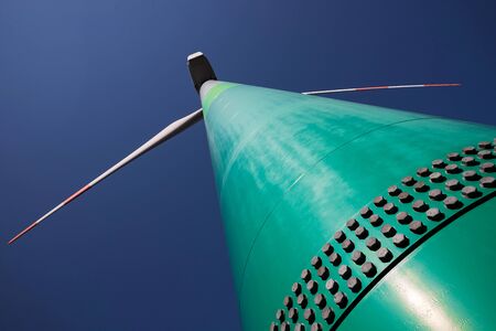 modern wind turbine in front of the evening sunの写真素材