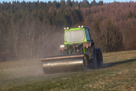 a tractor on a meadow in the evening