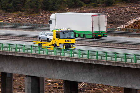 wilnsdorf, north rhine westphalia / germany - 17 03 2021: an german adac tow truck on an highwayのeditorial素材