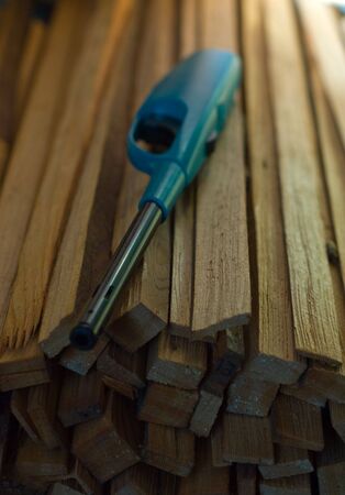 A pile of wood kindling with a trigger-operated lighter.の写真素材