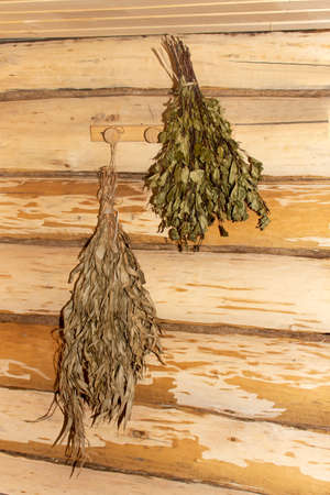 Wooden sauna in Russian interior style with accessories. Bucket and seats inside Russian bath.の写真素材