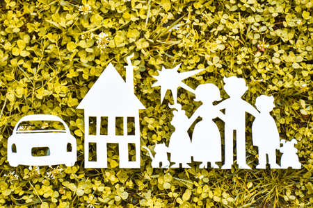 Paper family, house and car on a green grass. Family Life Insurance, protecting family, family and...