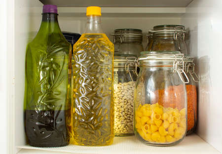 Pandemic pantry with stocked food. Emergency food prep during Coronavirus Covid-19 for survival. Supplies you need at home if you are quarantined. Prepping for quarantine - glass jars with provision.の写真素材
