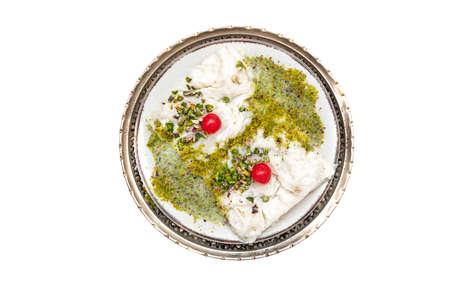 Traditional Turkish milky Ramadan Dessert named Gullac with sugar, powder of pistachio, milk and gullac sheets (rice wafer or rice paper sheets) on vintage metal plate isolated on white background.の写真素材
