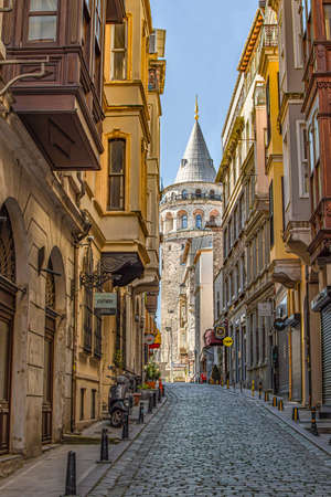 ISTANBUL, TURKEY - APRIL 09, 2020: View of famous tourist place Galata tower from Serdar-I Ekrem street, Beyoglu district during The Coronavirus pandemic. Nobody outside. Quarantine and self-isolationのeditorial素材