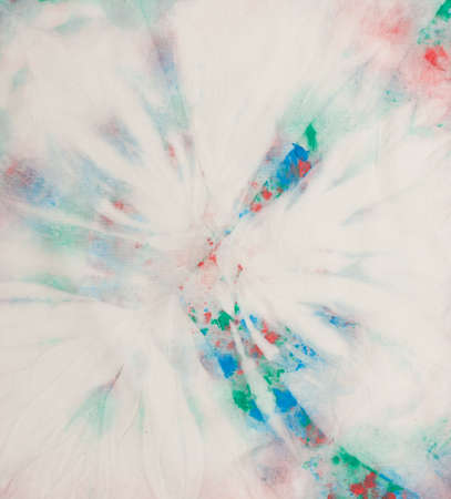 Close-up of tie dye texture background on cotton fabric. Trendy abstract pattern. Blue, green, pink, red and yellow colorsの写真素材