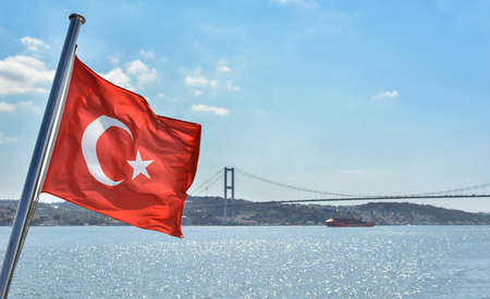 National Turkish flag waving on the wind, against blue sky usable for advertising, advertisement, election.の写真素材