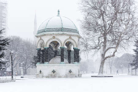 The beautiful landscape with German Fountain in old Hippodrome, Istanbul, Turkey one winter day with many snow. Snow storm in Istanbul in January 2021.の写真素材