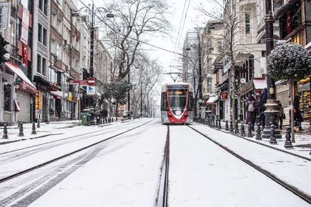 ISTANBUL, TURKEY - JANUARY 18, 2021: Modern tram is moving on the street in winter cold day with many snow. Snow storm in Turkey.のeditorial素材