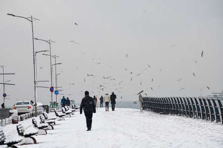 Magnificent view of coastline in Uskudar, Istanbul,Turkey. People walking near Bosphorus in winter day with many snow. Istanbul's main attractions.の写真素材