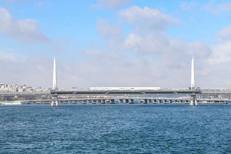 Panoramic view of Golden Horn Metro Bridge during cold winter day with many snow. Istanbul. Turkey.