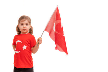 Cute little girl holding a Turkish flag isolated on white background.の写真素材