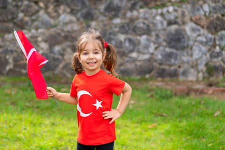Cute little girl with a flag of Turkey in her hands.の写真素材