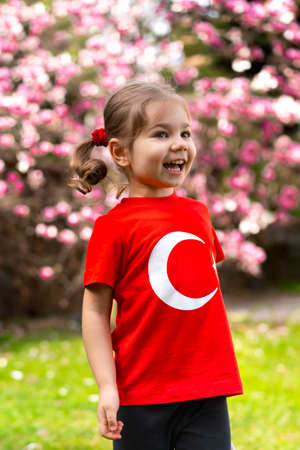 Cute little girl in a red T-shirt with the flag of Turkey.の写真素材